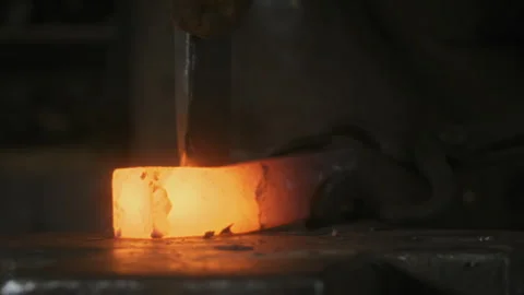 Blacksmith forging smelted metal with a chisel and hammer Stock Footage 275502309