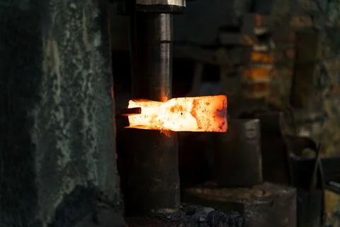 The blacksmith is forging very hot iron to make various tools. Stock Photos