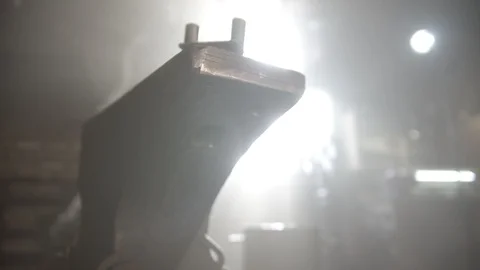 Blacksmith forging workshop with low lighting - man worker passing by Stock Footage 125364321