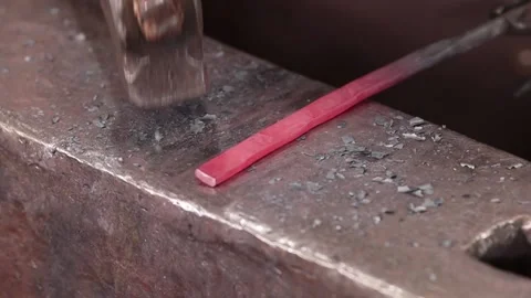 Blacksmith forging wrought iron at the anvil Stock Footage 133001320