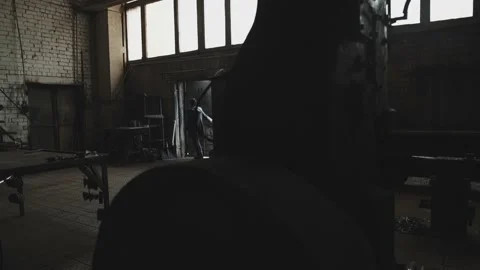 Blacksmith girl enters her workshop Stock Footage 155348911