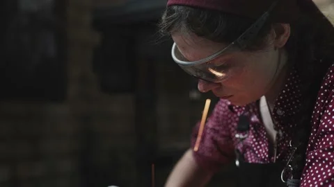 Blacksmith girl is grinding her sculpture Stock Footage
