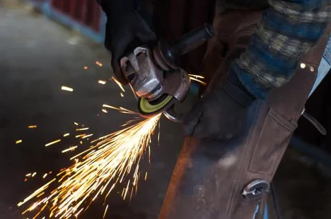 Blacksmith grinding the metal Stock Photos