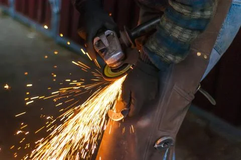 Blacksmith grinding the metal Stock Photos