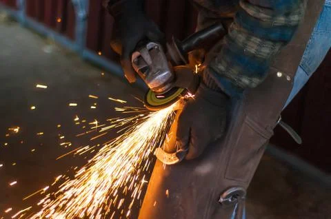 Blacksmith grinding the metal Stock Photos