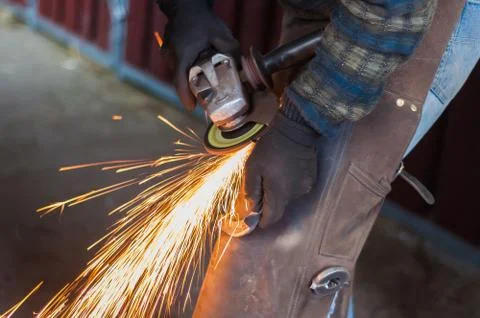 Blacksmith grinding the metal Stock Photos