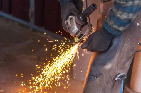 Blacksmith grinding the metal Stock Photos