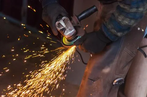Blacksmith grinding the metal Stock Photos