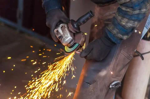 Blacksmith grinding the metal Stock Photos