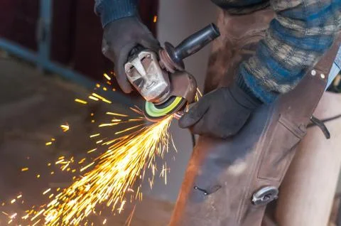 Blacksmith grinding the metal Stock Photos