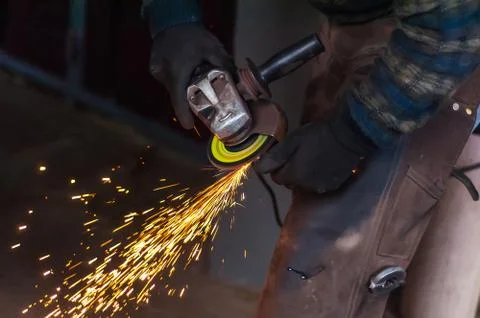 Blacksmith grinding the metal Stock Photos