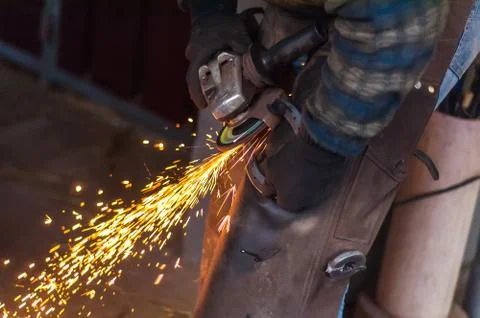 Blacksmith grinding the metal Stock Photos