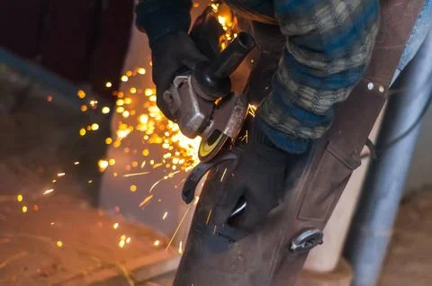 Blacksmith grinding the metal Stock Photos