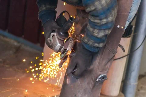Blacksmith grinding the metal Stock Photos