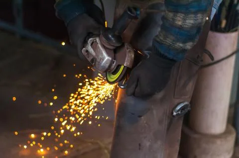 Blacksmith grinding the metal Stock Photos