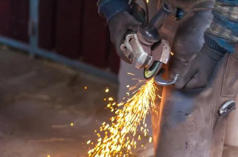 Blacksmith grinding the metal Stock Photos