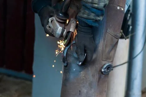 Blacksmith grinding the metal Stock Photos