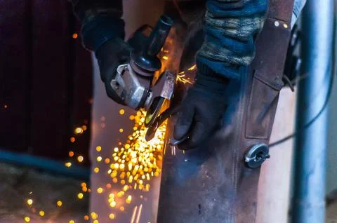 Blacksmith grinding the metal Stock Photos
