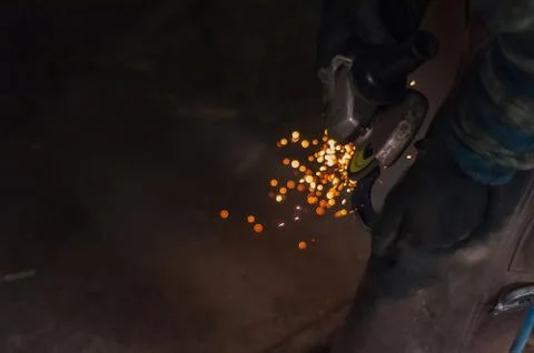 Blacksmith grinding the metal Stock Photos