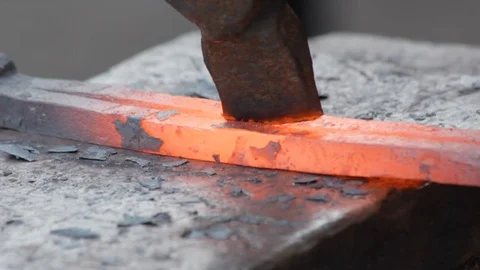 A blacksmith hack by chisel and hammer a channel groove to hot horseshoe. Stock Footage 120260481