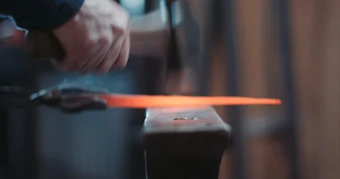 Blacksmith hamering long iron nail Stock Footage 105295374