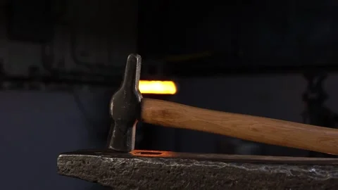 Blacksmith Hammer on Anvil in a Forge with Lateral Movement Stock Footage 255408743