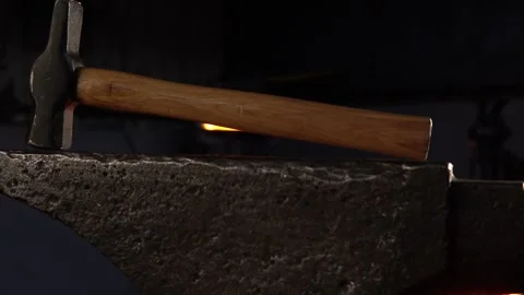 Blacksmith Hammer on Anvil in a Forge with Vertical Movement Stock Footage 255408745
