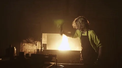 Blacksmith hammer processes the workpiece. Cool light from the oven Stock Footage 108956757