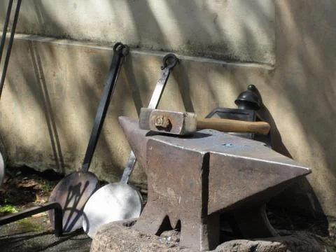 Blacksmith hammer resting on the anvil Stock Photos