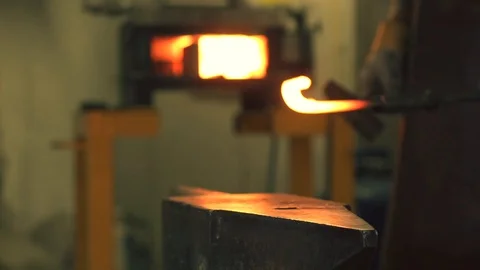 Blacksmith hammering hot iron on the anvil Stock Footage 128596942