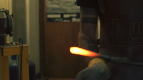Blacksmith hammering hot iron in the smithy Stock Footage 128596850