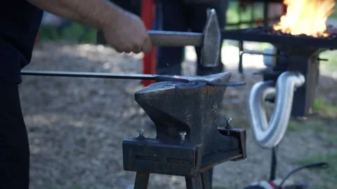 Blacksmith Hammering Metal Beside Forge Fire Stock Footage 340321027