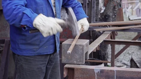Blacksmith hammering on a metal rod Stock Footage 101951532