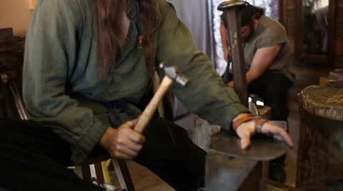 Blacksmith hammering a piece of metal Stock Footage 44631721