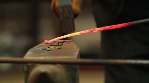 Blacksmith hammering red hot iron on anvil Stock Footage 72219847
