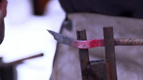 Blacksmith is hammering a red-hot piece of iron Stock Footage 82227241