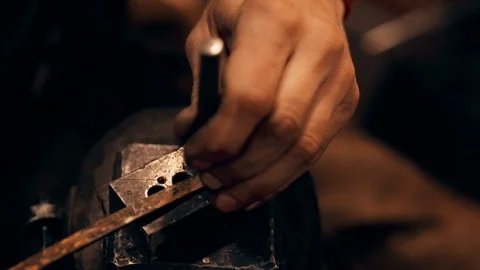 A blacksmith is hammering a small knife on an anvil. Close up. Room. Stock Footage 122325174