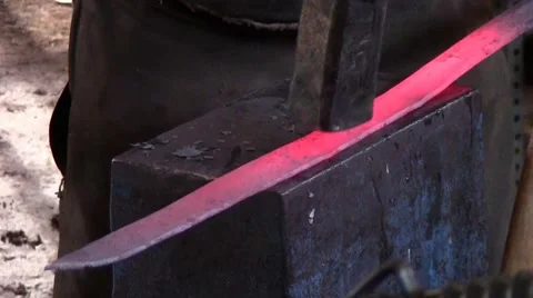 Blacksmith hammering a sword Stock Footage