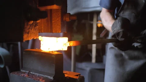 A blacksmith hammers hot iron with a mechanical hammer Video stock 205485700