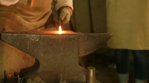 Blacksmith hammers on the red-hot piece of iron Stock Footage 60641969