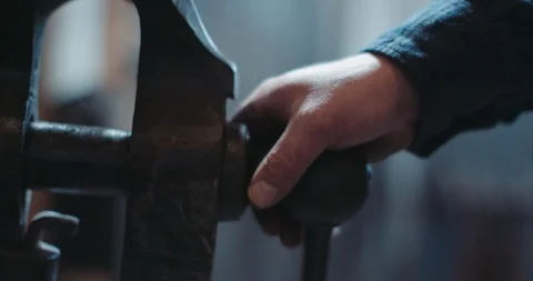 Blacksmith hand on an old rustic vice Stock Footage 105306322