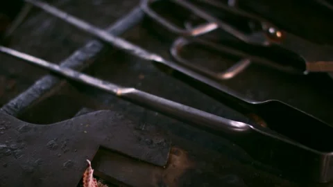 Blacksmith Hand Tools Lying on Dark Anvil, Traditional Forge, Close Up Shot Stock Footage 341337697