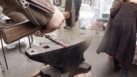 Blacksmith Handles The Workpiece by Hammer on The Anvil Stock Footage 74794064