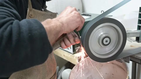 Blacksmith hands shaping a metal knife Stock Footage 164934108