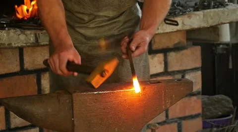 Blacksmith has an effort on glowing hot metal and sparks fly in all directions 스톡 동영상 49689394