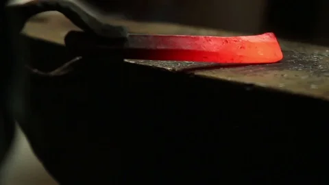 Blacksmith has an effort on glowing hot metal Stock-Footage 72218509