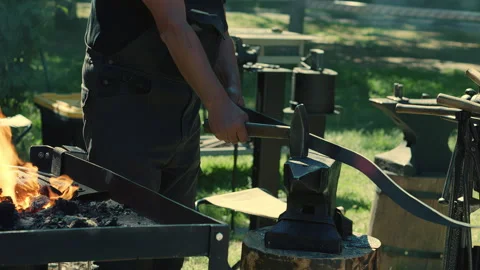 Blacksmith Heating Metal Bar Beside Anvil Stock Footage 341575383