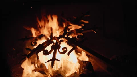 Blacksmith heating up a metal cross 動画素材 147728980