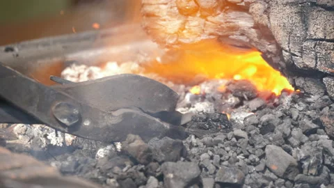 Blacksmith heating steel in charcoal forge slow motion 4k Stock Footage 138274059