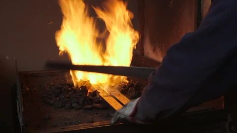 Blacksmith Heating Steel in Traditional Forge with Intense Flames Video stock 340016830